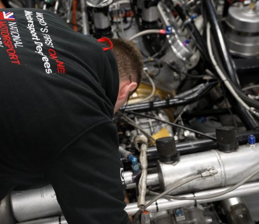A student from the National Motorsport Academy working on a racecar
